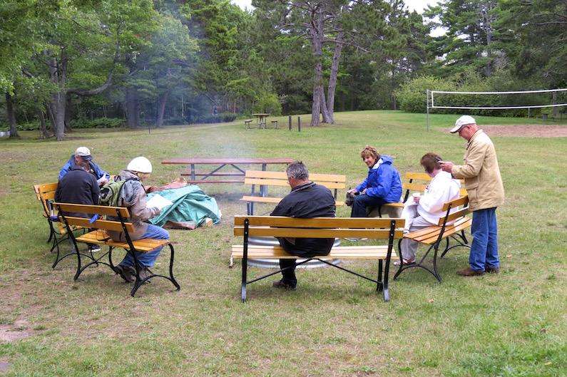 Great Hobby for RVers: Geocaching 3 This Geocaching event was a day long hunt in the Fort Wilkins State Park in Cper Harbor, MI. Geocachers, many of them RVers, had a campfire, a shared meal with lots of snacks, and they spent the day searching the Upper Peninsula Park for geocaches. That's Jennifer in the blue jacket with Tai, learning the ropes from the veteran geocachers.