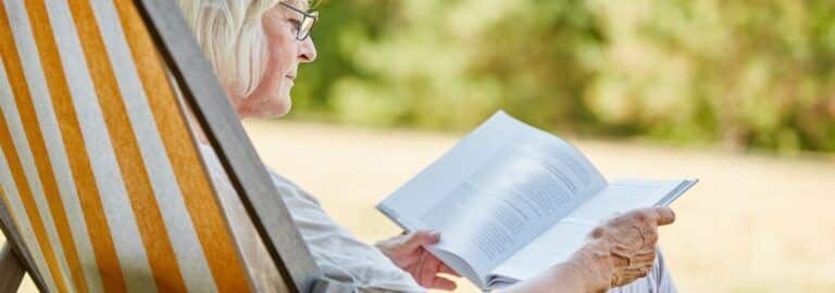 woman reading book outdoors